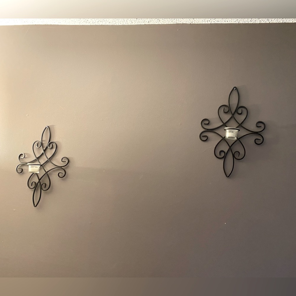 Pair of black metal sconces w candle holder. Approx. 16” H x 11” W.